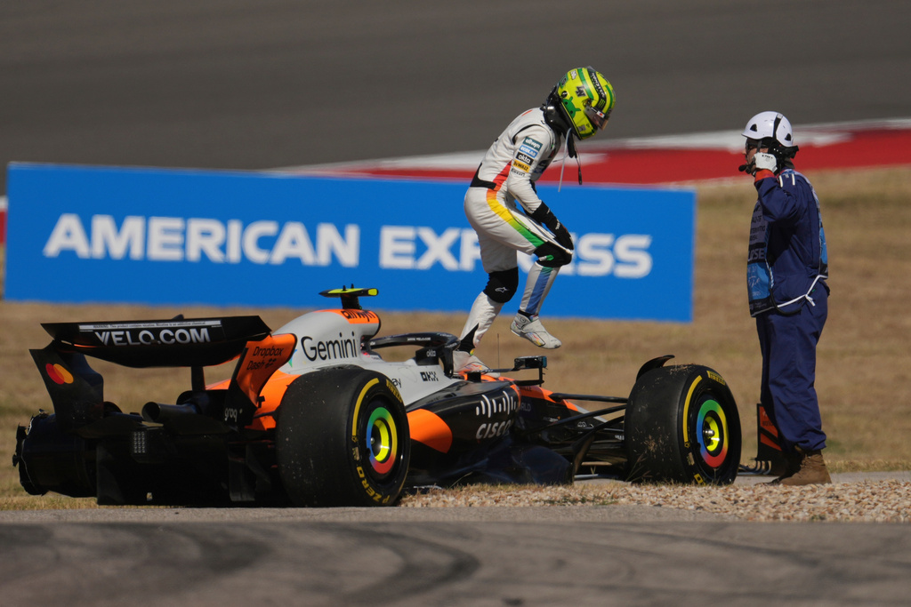 McLaren driver Lando Norris of Britain exits his damaged car during the sprint race at the Formula One U.S. Grand Prix auto racing in Austin, Texas, Saturday, Oct. 18, 2025.(AP Photo/Eric Gay)