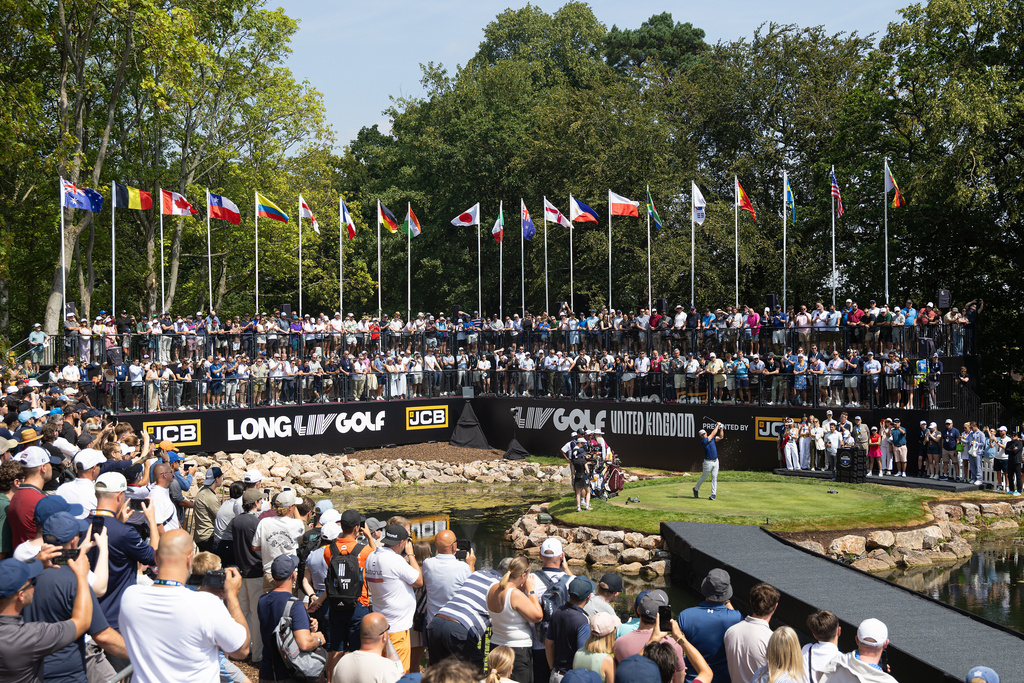 Captain Bryson DeChambeau, center right, of Crushers GC hits from the first tee during the second round of LIV Golf United Kingdom, Friday, July 24, 2026, in Rocester, England. (Chris Trotman/LIV Golf via AP)