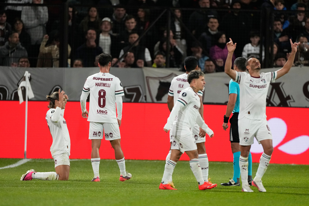 Agustin Canobbio of Brazil's Fluminense, left, celebrates with teammates after scoring his side's opening goal against Argentina's Platense during a Copa Libertadores quarter final second leg soccer match in Buenos Aires, Argentina, Tuesday, Sept. 15, 2026. (AP Photo/Gustavo Garello)