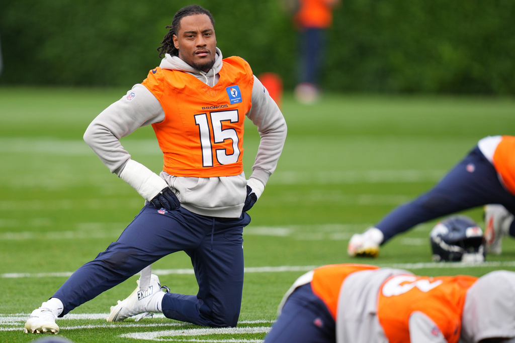 Denver Broncos linebacker Nik Bonitto (15) stretches during an NFL training session at Tottenham Hotspur training ground in London, Wednesday, Oct. 8, 2025. (AP Photo/Kirsty Wigglesworth)