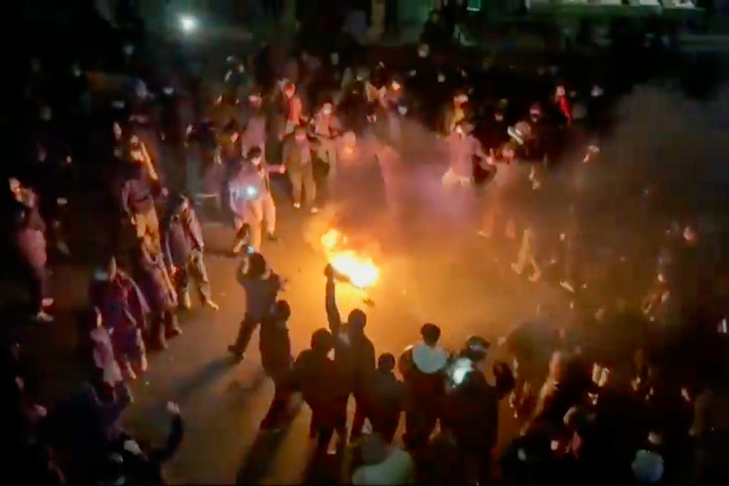 In this frame grab from footage circulating on social media shows protesters dancing and cheering around a bonfire as they take to the streets despite an intensifying crackdown as the Islamic Republic remains cut off from the rest of the world, in Tehran, Iran, Friday, Jan. 9, 2026.(UGC via AP)