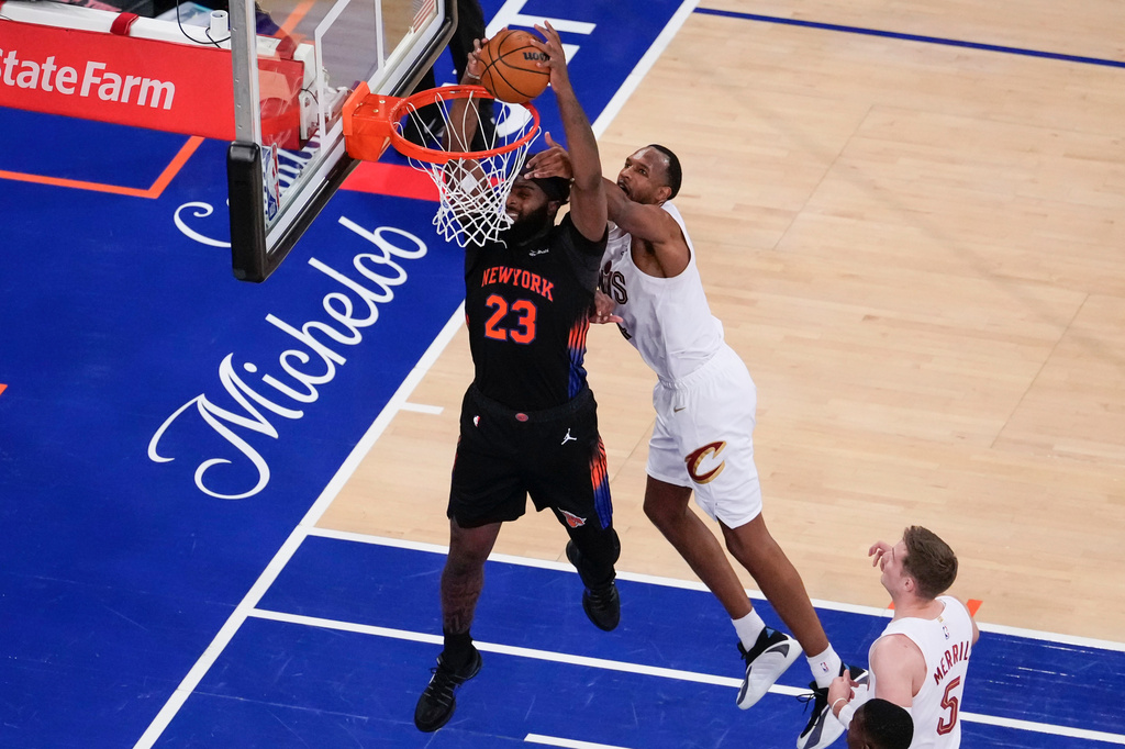 New York Knicks center Mitchell Robinson (23) dunks past Cleveland Cavaliers center Evan Mobley (4) during the second half of Game 2 in the Eastern Conference finals NBA basketball playoffs series, Thursday, May 21, 2026, in New York. (AP Photo/Yuki Iwamura)