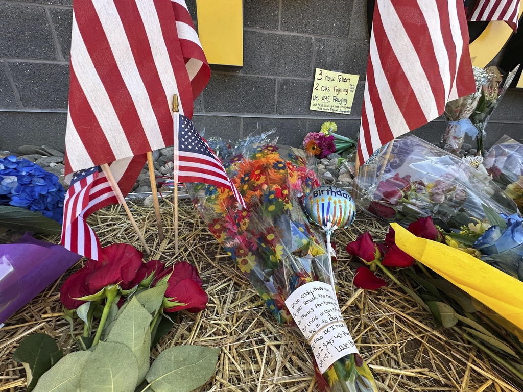 A memorial for police officers killed in a shooting is shown outside the Northern York County Regional Police Department, Thursday, Sept. 18, 2025 in York, Pa. (AP Photo/Tassanee Vejpongsa)