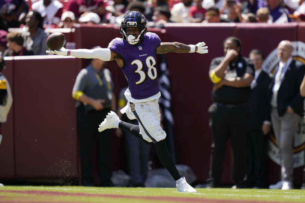 Baltimore Ravens cornerback Keyon Martin (38) celebrates after intercepting a pass and running it back for a touchdown during the first half of a preseason NFL football game against the Washington Commanders Saturday, Aug. 23, 2025, in Landover, Md. (AP Photo/Stephanie Scarbrough)
