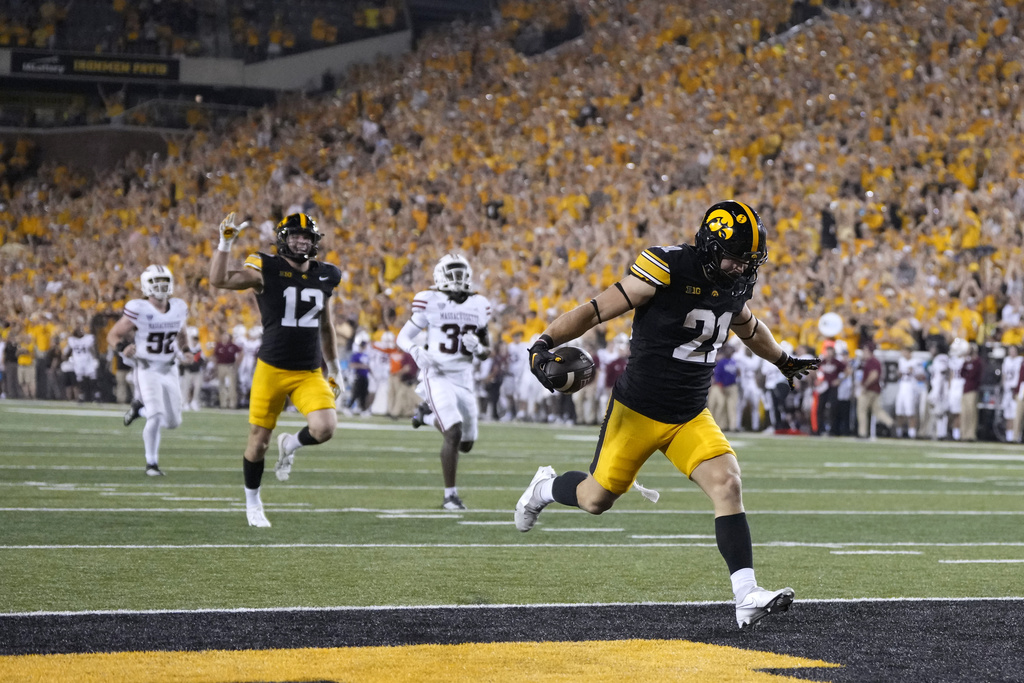 Iowa's Kaden Wetjen (21) celebrates as he returns a punt for a touchdown during the second half of an NCAA college football game against Massachusetts, Saturday, Sept. 13, 2025, in Iowa City, Iowa. (AP Photo/Charlie Neibergall)