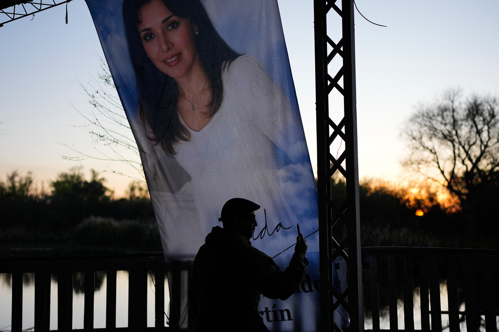 A man takes a picture at a sanctuary dedicated to Argentine singer Gilda on the 30th anniversary of her death in a bus crash, in Entre Rios, Argentina, Monday, Sept. 7, 2026. (AP Photo/Natacha Pisarenko)