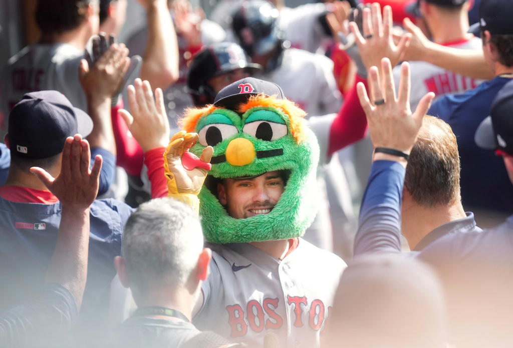 Boston Red Sox third baseman Caleb Durbin (5) celebrates his grand slam with teammates in the dugout while playing against the Toronto Blue Jays during the eighth inning of a baseball game in Toronto, Thursday, Aug. 13, 2026. (Nathan Denette/The Canadian Press via AP)