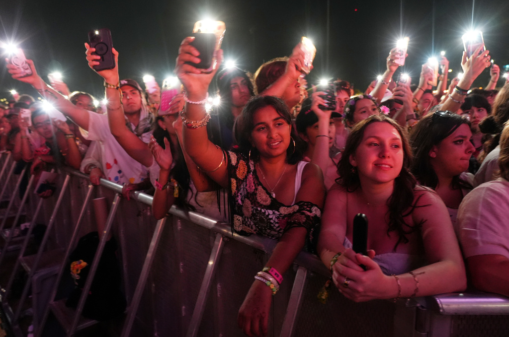 Audience members watch Olivia Rodrigo perform with special guest Sarah McLachlan at the Daisy Chain Fields Music Festival on Saturday, Aug. 29, 2026, at Great Park in Irvine, Calif. (AP Photo/Chris Pizzello)