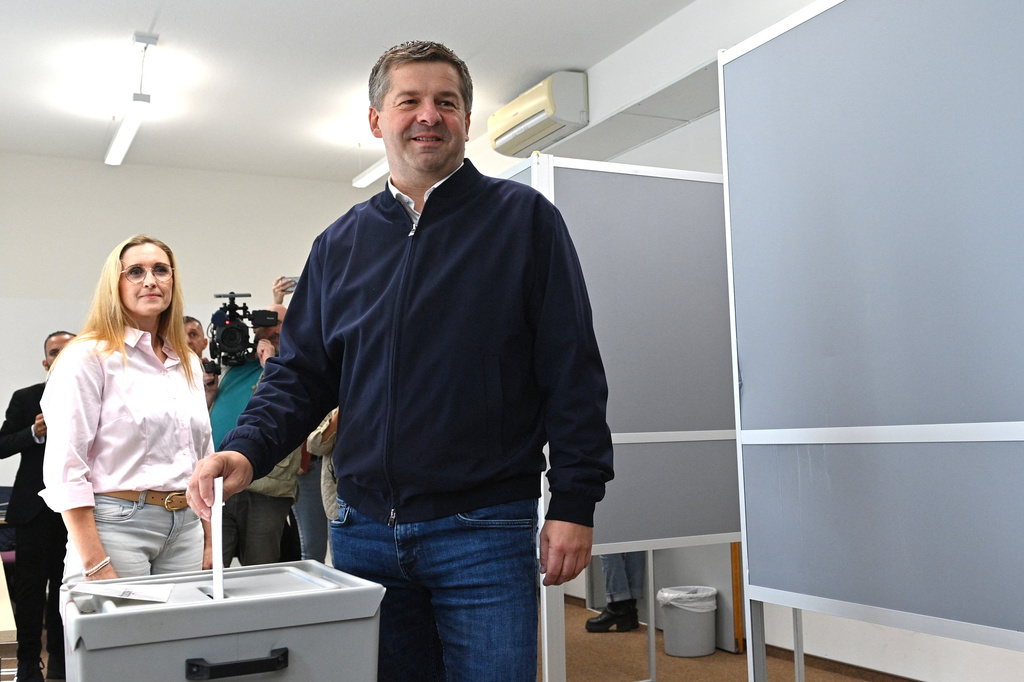 Sven Schulze, Minister-President of Saxony-Anhalt and state chairman of the CDU in Saxony-Anhalt, drops his ballot into the ballot box during the Saxony-Anhalt state election, in Magdeburg, Germany, Sunday Sept. 6, 2026. At left is his wife Kati Schulze. (Klaus-Dietmar Gabbert/dpa via AP)