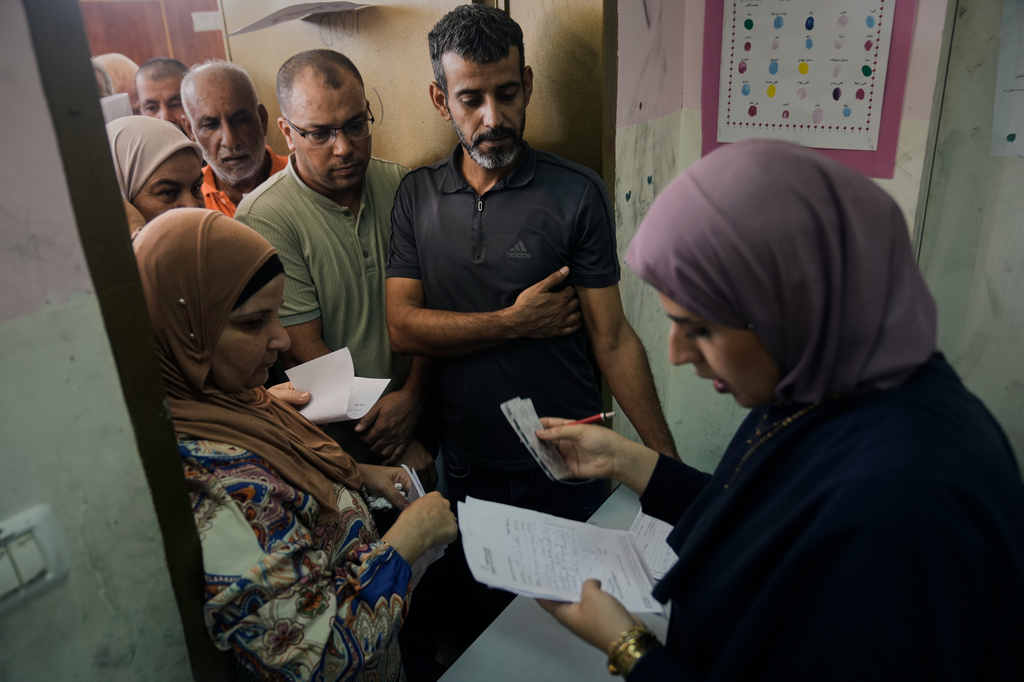 Palestinian patients line up for treatment at a mobile health clinic operated by Physicians for Human Rights Israel (PHRI) in the West Bank town of Iktaba, Tuesday, Aug. 4, 2026. (AP Photo/Majdi Mohammed)