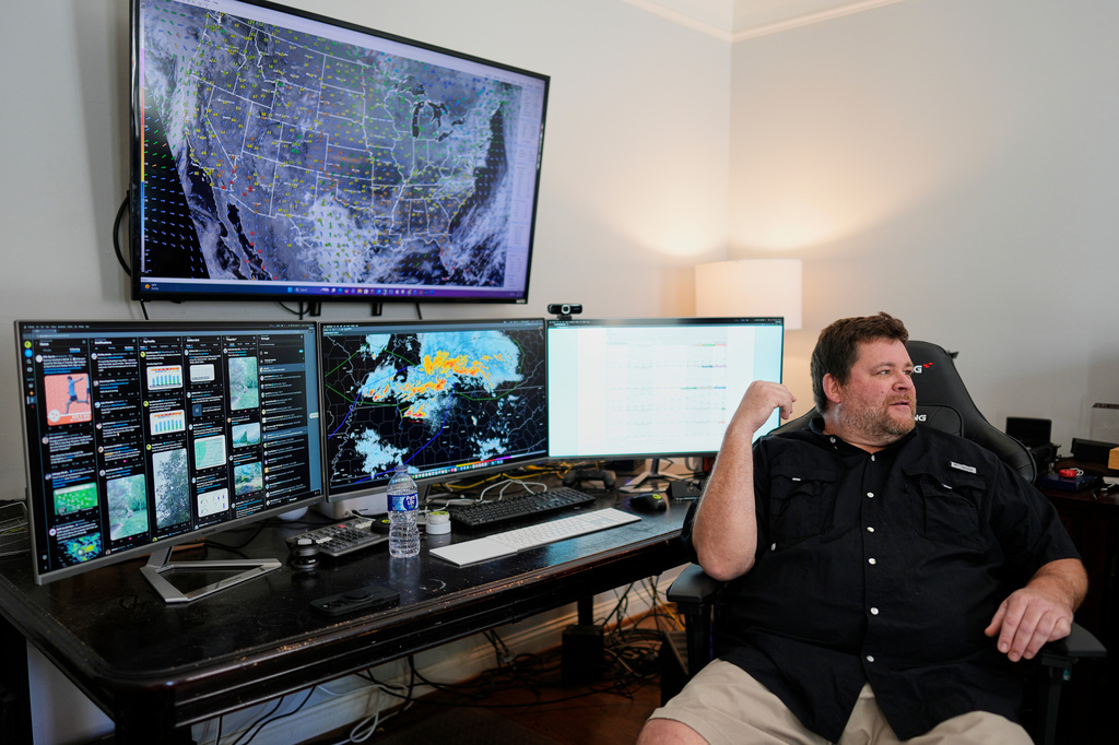 Will Minkoff of Nashville Severe Weather sits at his desk Monday, April 20, 2026, in Nashville, Tenn. (AP Photo/George Walker IV)