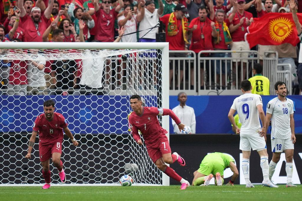 Portugal's Cristiano Ronaldo (7) celebrates after scoring the opening goal of his team during the World Cup Group K soccer match between Portugal and Uzbekistan in Houston, Tuesday, June 23, 2026. (AP Photo/Eric Gay)