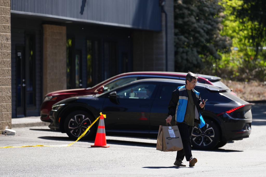 A driver picks up an order at an Amazon Now location, Monday, May 11, 2026, in Bellevue, Wash. (AP Photo/Lindsey Wasson)