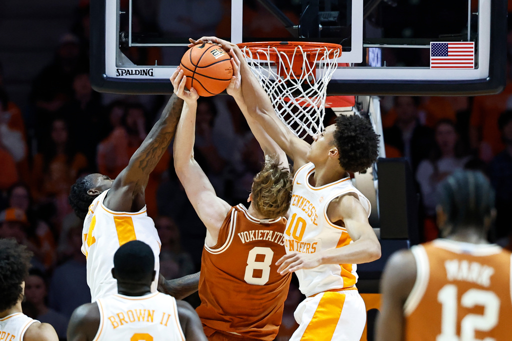 Texas center Matas Vokietaitis (8) has his shot blocked by Tennessee forward Nate Ament (10) and center Felix Okpara (34) during the first half of an NCAA college basketball game Tuesday, Jan. 6, 2026, in Knoxville, Tenn. (AP Photo/Wade Payne)