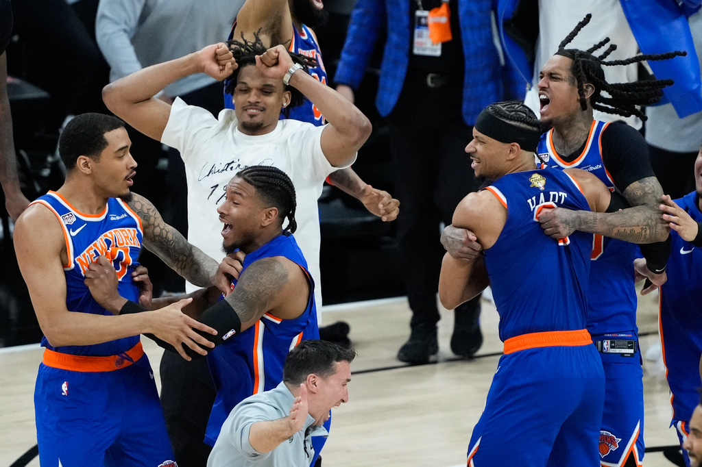The New York Knicks celebrate after defeating the San Antonio Spurs in Game 5 of the NBA Finals basketball series, Saturday, June 13, 2026, in San Antonio. (AP Photo/Ross D. Franklin)