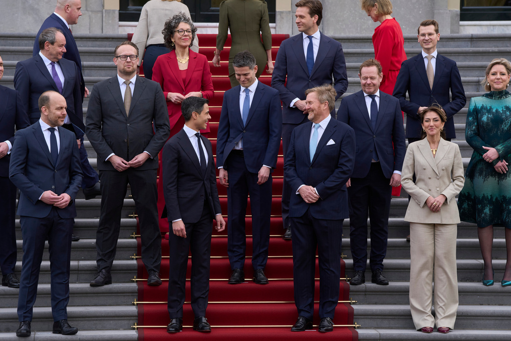 Ministers of the new three-party minority government pose with King Willem-Alexander, center right, prime minster Rob Jetten, center left, and deputy prime minister Dilan Yesilgöz, front row right, on the steps of Royal Palace Huis ten Bosch in The Hague, Netherlands, Monday, Feb. 23, 2026. (AP Photo/Peter Dejong)