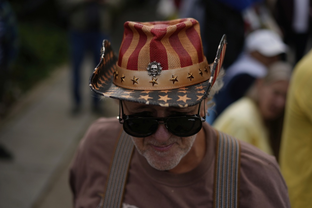 Mark Melgosa joins as people gather during Illinois Coalition for Immigrant & Refugee Rights' "Chicago Says No Trump No Troops" protest Saturday, Sept. 6, 2025, in Chicago. (AP Photo/Carolyn Kaster)