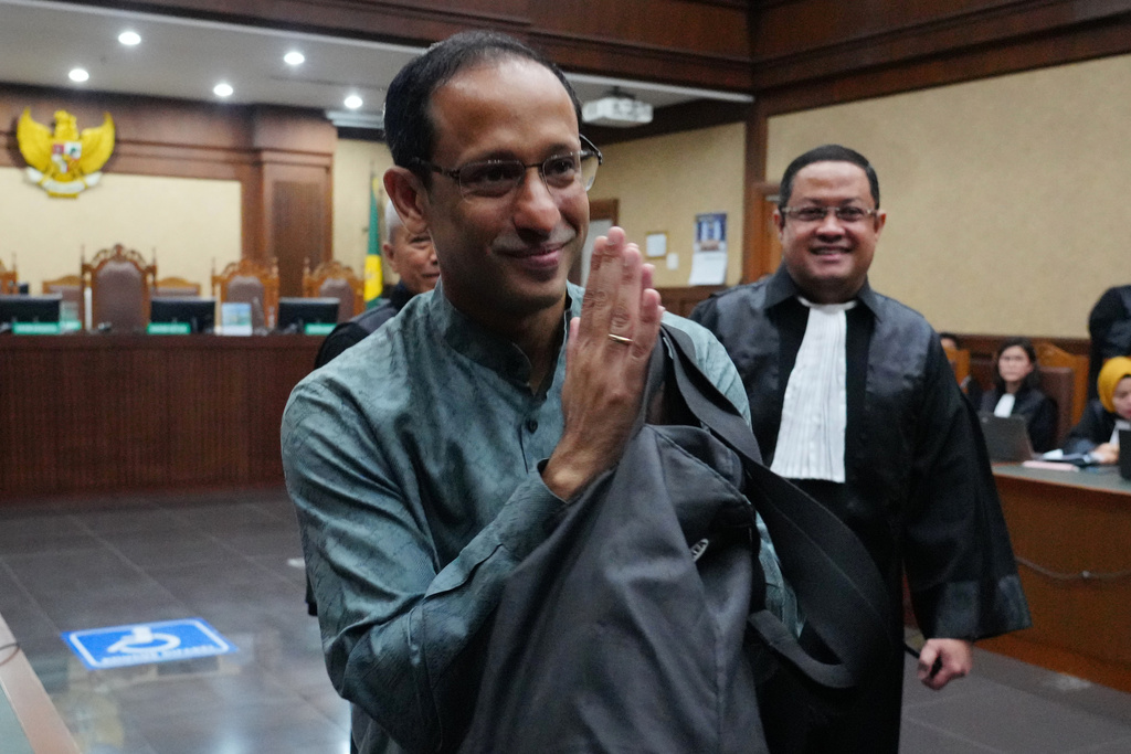 Nadiem Anwar Makarim, the co-founder of Indonesia's payments platform and ride hailing company Gojek and former education minister, reacts as he enters the courtroom for his first trial hearing at the Corruption Court in Jakarta, Indonesia, Monday, Jan. 5, 2026. (AP Photo/Tatan Syuflana)