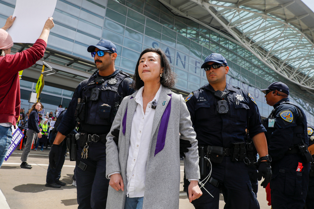 Supervisor Connie Chan is arrested as she stands with other demonstrators blocking the road in front of San Francisco International terminal during ICE Out of San Francisco protest at SFO on May Day at San Francisco International Airport on Friday, May 1, 2026, in San Francisco. (Lea Suzuki/San Francisco Chronicle via AP)
