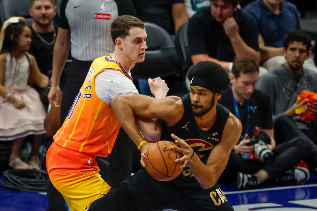 Cleveland Cavaliers center Jarrett Allen, right, drives against Charlotte Hornets center Ryan Kalkbrenner, left, during the first half of an NBA basketball game in Charlotte, N.C., Friday, Feb. 20, 2026. (AP Photo/Nell Redmond)