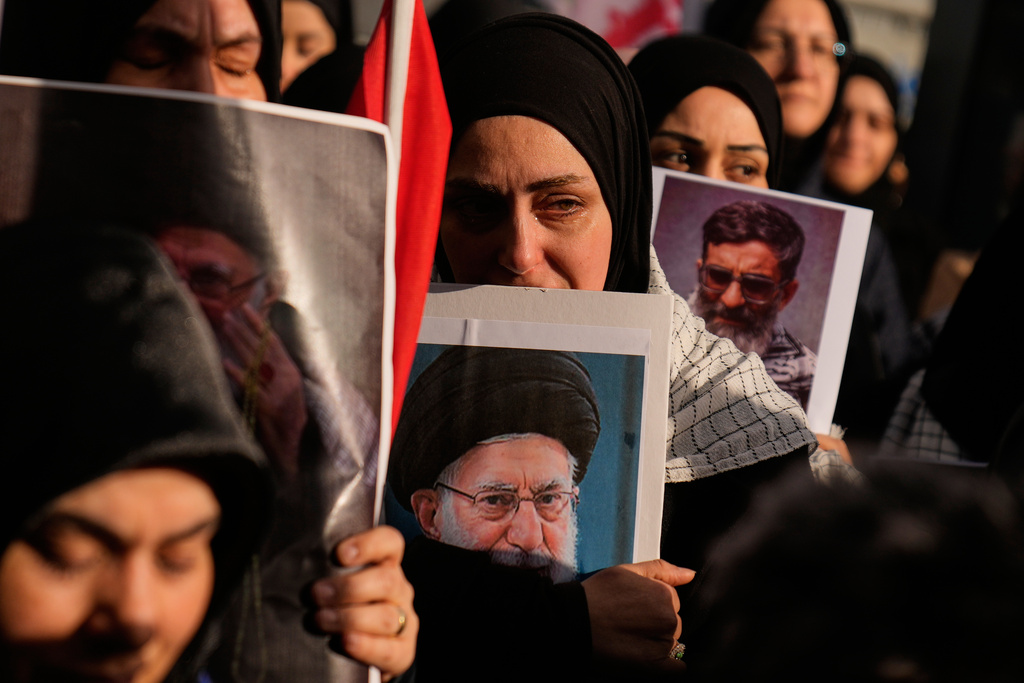 Demonstrators mourn the death of Iranian Supreme Leader Ayatollah Ali Khamenei while holding his pictures during a protest outside the Israeli consulate in Istanbul, Sunday, March 1, 2026. (AP Photo/Khalil Hamra)