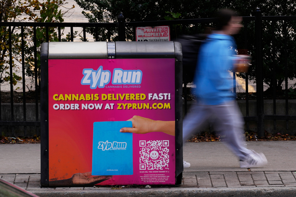 An advertisement for a cannabis delivery company is seen on a public trash bin Sunday, Nov. 16, 2025, in Boston. (AP Photo/Robert F. Bukaty)