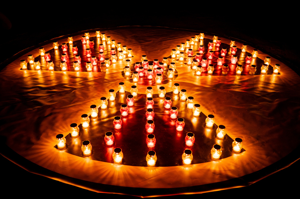 Candles arranged into a radiation hazard symbol at a memorial dedicated to firefighters and workers who died after the 1986 Chornobyl (Chernobyl) nuclear disaster, ahead of its 40th anniversary in Slavutych, Ukraine, Saturday, April 25, 2026. Chornobyl is the Ukrainian name for the city. (AP Photo/Dan Bashakov)