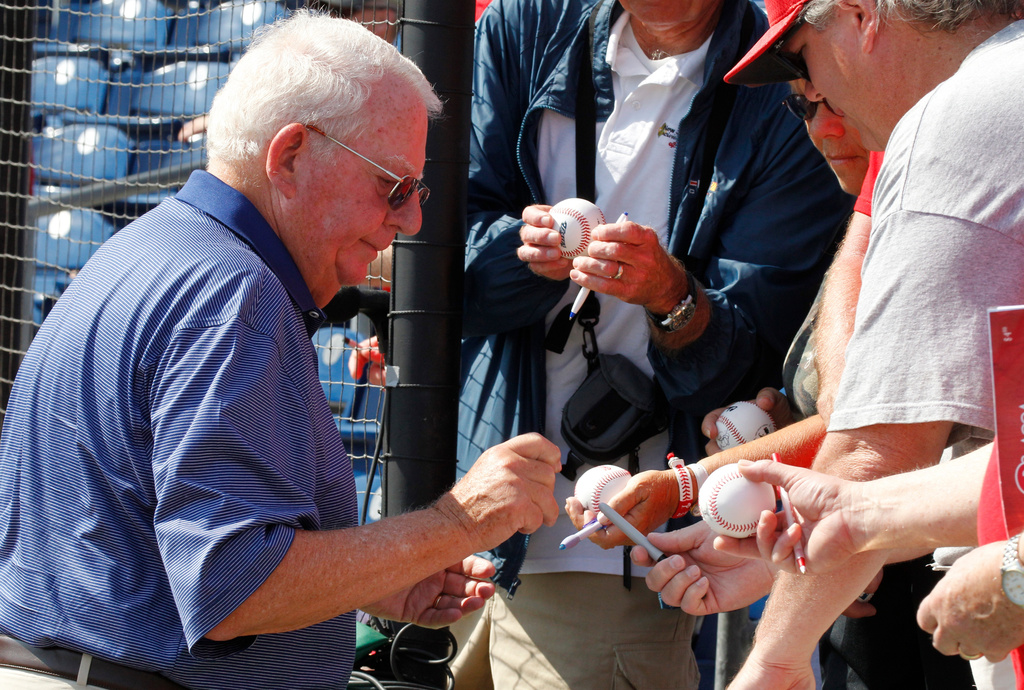 FILE - Philadelphia Phillies chairman Bill Giles signs autographs before a spring training baseball game in Clearwater, Fla., Monday, March 21, 2011. (AP Photo/Gene J. Puskar,File)