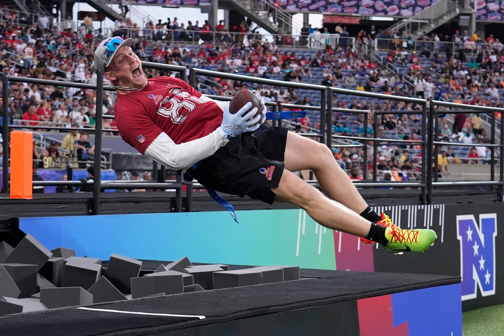 FILE - Arizona Cardinals tight end Trey McBride celebrates his touchdown jumping in a foam pit during the NFL Pro Bowl football game, Feb. 2, 2025, in Orlando, Fla. (AP Photo/John Raoux, File)