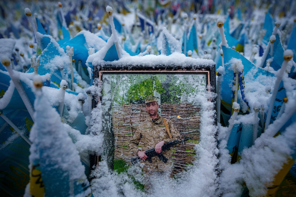 FILE - Snow covers the photograph of a fallen Ukrainian serviceman in downtown Kyiv, Ukraine, Tuesday, March 12, 2024. (AP Photo/Vadim Ghirda, File)