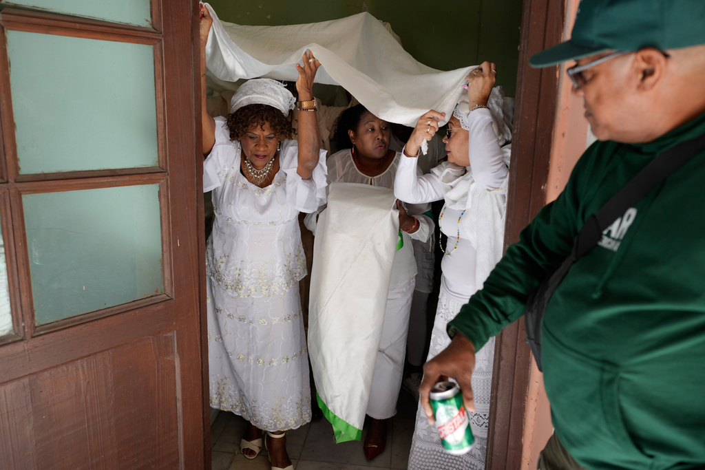 FILE - Santeria followers prepare to perform a holy drum beat after the reading of the Letter of the Year, an annual prophecy from the Yoruba Cultural Association of Cuba, in Havana, Jan. 2, 2026. (AP Photo/Ramon Espinosa, File)