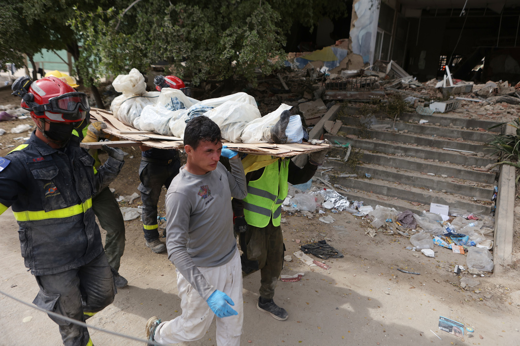 Rescue workers carry the body of an earthquake victim in La Guaira, Venezuela, Sunday, June 28, 2026. (AP Photo/Pedro Mattey)