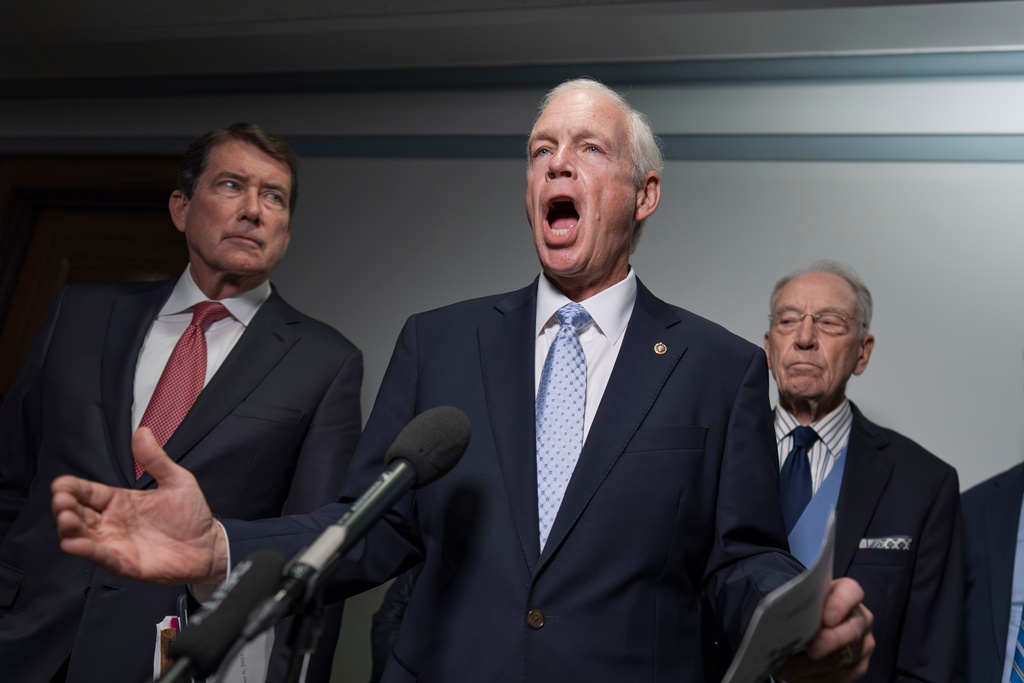 Sen. Ron Johnson, R-Wis., chairman of the Permanent Subcommittee on Investigations, center, is flanked by Sen. Bill Hagerty, R-Tenn., left, and Senate Judiciary Committee Chairman Chuck Grassley, R- Iowa, speak with reporters as they make an announcement about their oversight of the FBI, at the Capitol in Washington, Monday, Oct. 6, 2025. (AP Photo/J. Scott Applewhite) Sen. Marsha Blackburn, R-Tenn.,