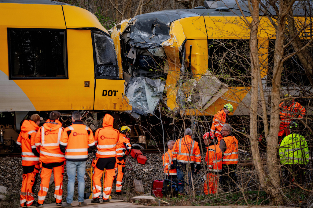 Emergency personnel work at the site where two trains collided near Hilleroed, Denmark, on Thursday, April 23, 2026. (Mads Claus Rasmussen/Ritzau Scanpix via AP)