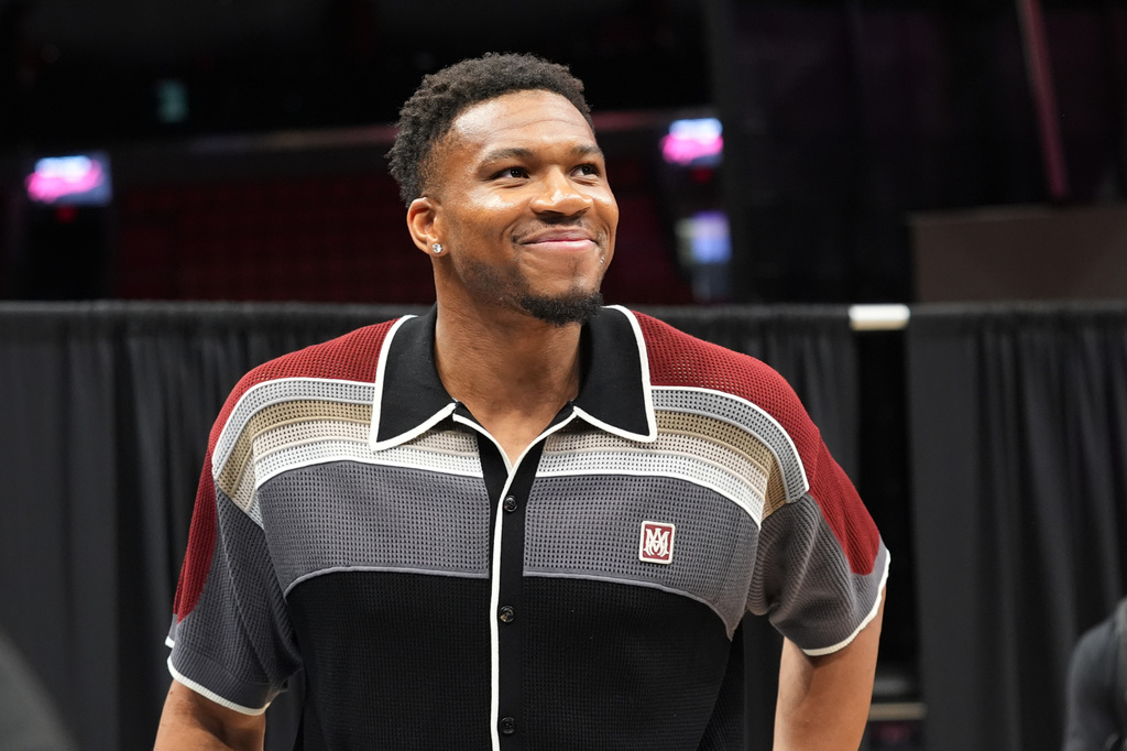 Giannis Antetokounmpo smiles after a news conference where he was introduced as a new Miami Heat player Thursday, July 16, 2026, in Miami. (AP Photo/Marta Lavandier)