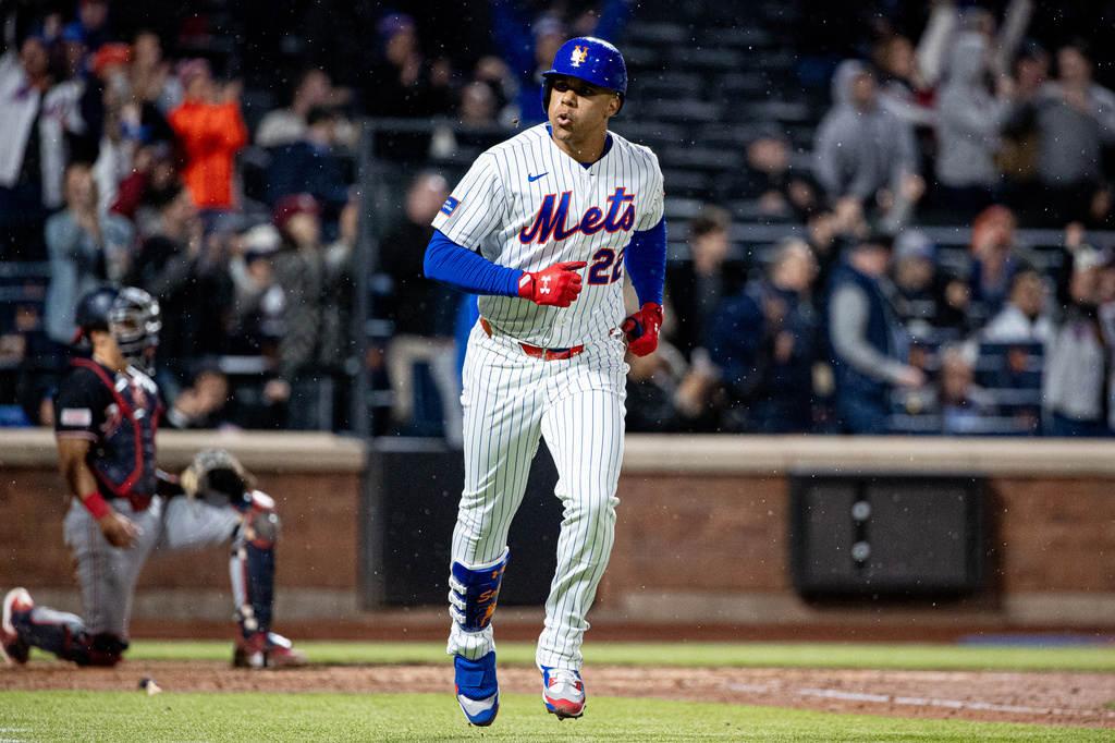 New York Mets' Juan Soto (22) spits out a seed as he scores a two-run home run during the fourth inning of a baseball game against the Washington Nationals, Tuesday, April 28, 2026, in New York. (AP Photo/Angelina Katsanis)