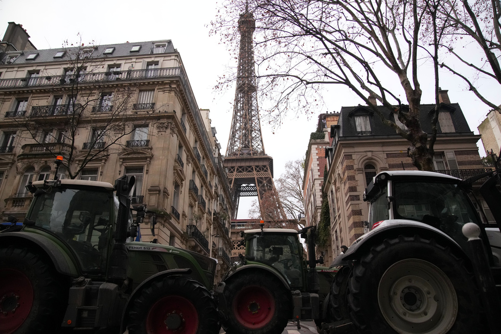 Tractors line up near the Eiffel Tower as farmers protest the European Union intention to move forward with the Mercosur trade deal with five South American nations, in Paris Thursday, Jan. 8, 2026 in Paris. (AP Photo/Christophe Ena)