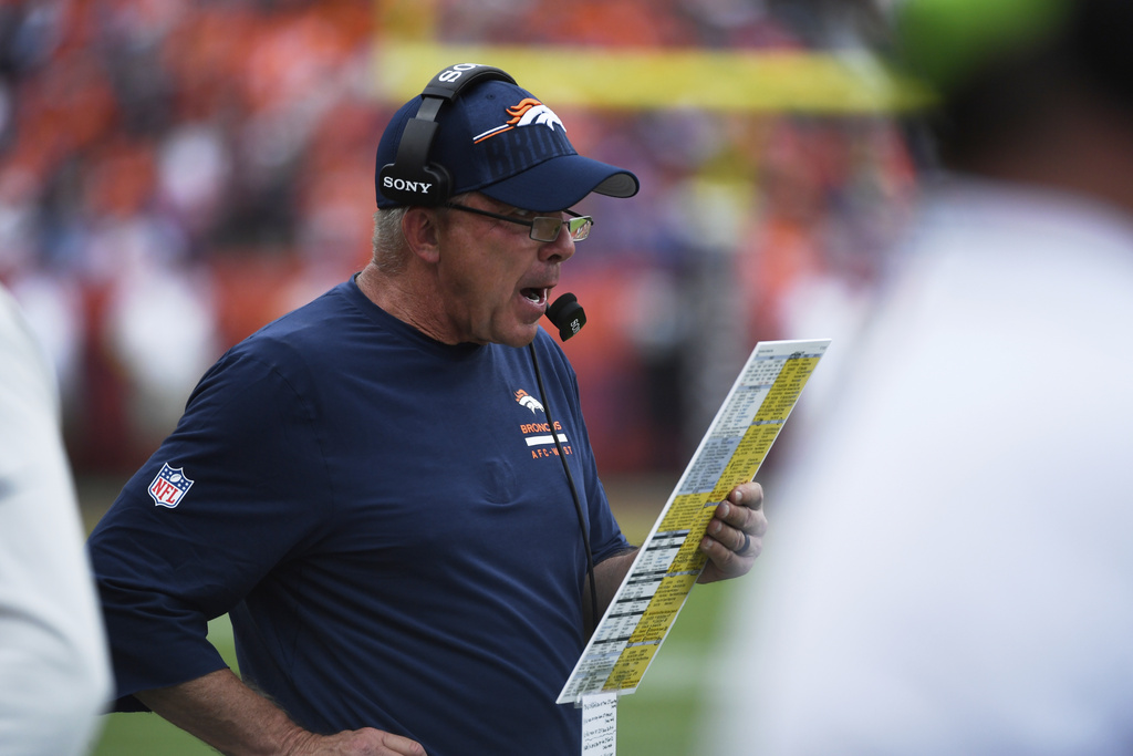 Denver Broncos head coach Sean Payton checks his play sheet in the second half of an NFL football game against the Tennessee Titans, Sunday, Sept. 7, 2025, in Denver. (AP Photo/Eric Lutzens)