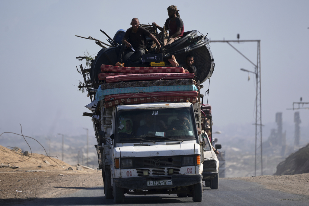 Displaced Palestinians fleeing northern Gaza carry their belongings in a car along the coastal road toward southern Gaza, Tuesday, Sept. 9, 2025, after the Israeli army issued evacuation orders from Gaza City. (AP Photo/Jehad Alshrafi)