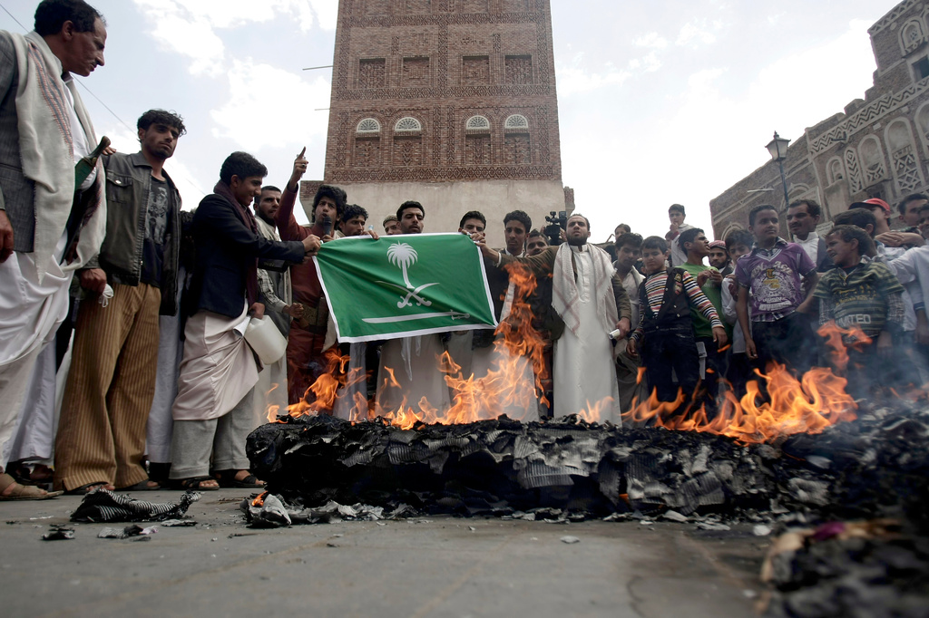FILE - Members of the Yemeni al-Houthi Shiite rebel group burn an effigy of a U.S. aircraft and a Saudi flag during a demonstration against U.S. and Saudi interference in Yemen, after Friday prayer in Sanaa, Yemen, on April 12, 2013. (AP Photo/Hani Mohammed), File