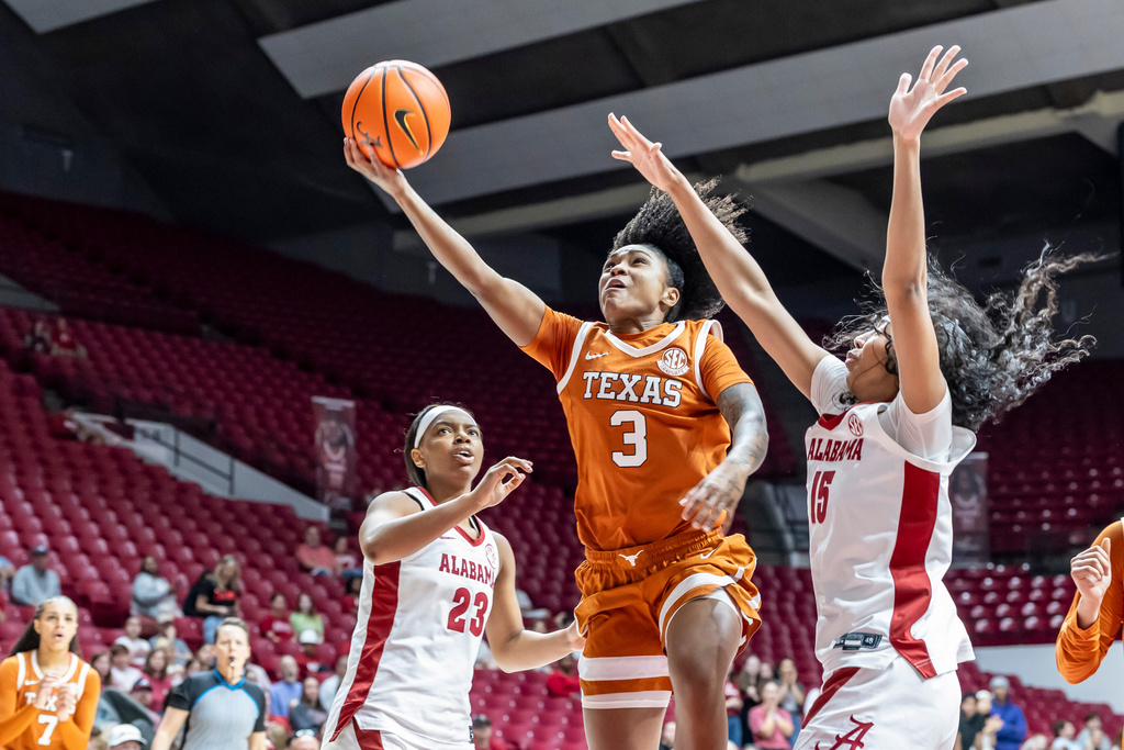 Texas guard Rori Harmon (3) works inside past Alabama guards Jessica Timmons (23) and Ta'Mia Scott (15) during the first half of an NCAA college basketball game Sunday, March 1, 2026, in Tuscaloosa, Ala. (AP Photo/Vasha Hunt)