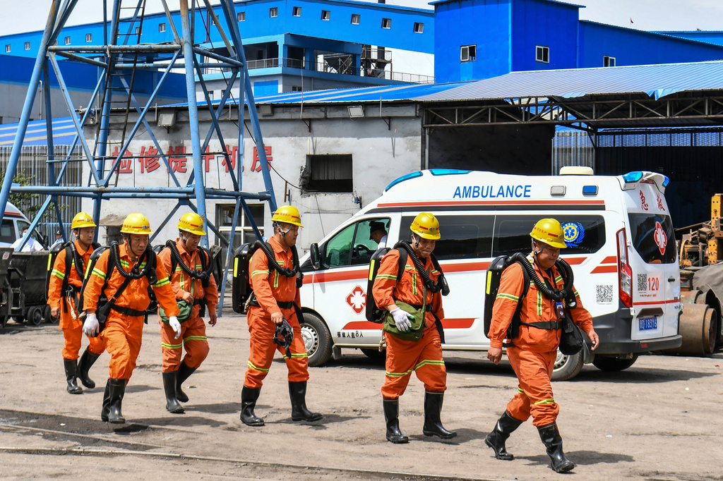 In this photo released by Xinhua News Agency, rescue workers pass by an ambulance in the aftermath of an explosion at Changzhi city's Liushenyu coal mine in Qinyuan county, northern China's Shanxi Province on Saturday, May 23, 2026. (Cao Yang/Xinhua via AP)