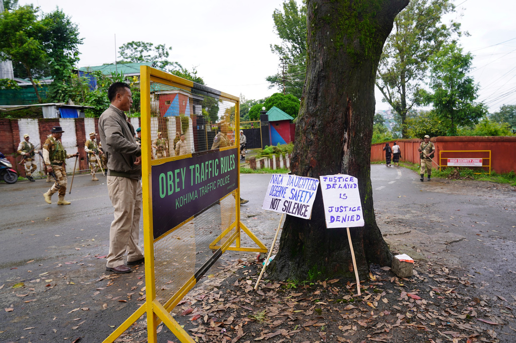 Police clear a barricade after a protest against rising cases of sexual violence against women and demanding justice for victims, in Kohima, capital of the northeastern Indian state of Nagaland, Friday, June 19, 2026. (AP Photo/Yirmiyan Arthur)