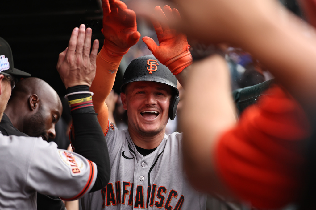 The San Francisco Giants' Matt Chapman celebrates in the dugout after hitting a grand slam during the fourth inning of a baseball game against the Chicago Cubs, Friday, June 5, 2026, in Chicago. (AP Photo/Geoff Stellfox)