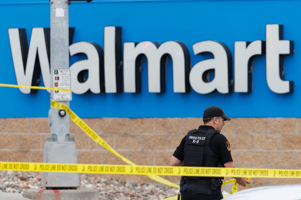 Omaha police work outside a Walmart store at South 72nd and Pine Streets in Omaha, Neb., on Tuesday, April 14, 2026, after police fatally shot a woman who was accused of cutting a young child's face with a knife. (Nikos Frazier/Omaha World-Herald via AP)
