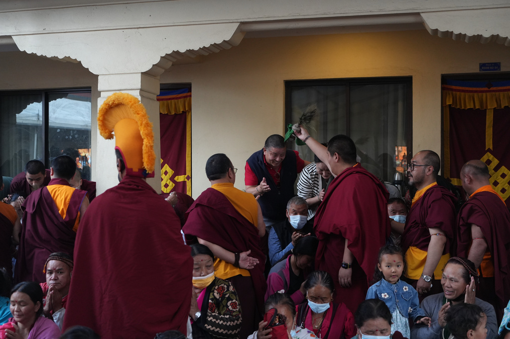 U.S.-born Buddhist lama Jalue Dorje blesses his father, Dorje Tsegyal, and mother, Dechen Wangmo, at the end of 12 days of empowerments, or initiation rituals and teachings, bestowed by the abbot of Shechen Monastery in Kathmandu, Nepal, on Sunday, April 12, 2026. (AP Photo/Luis Andres Henao)