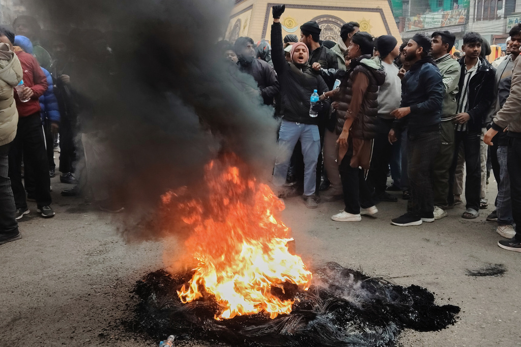 Protesters shout slogans and burn tires as they block main Street in Birgunj, 130 kilometers (81miles) south of Katmandu, Nepal, Sunday, Jan. 4, 2026. (AP Photo/Jiyalal Sah)