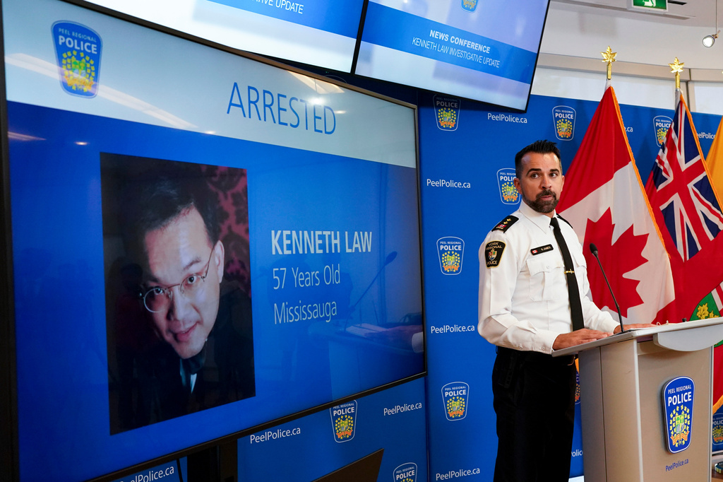 FILE - York Regional Police Inspector Simon James speaks during a news conference in Mississauga, Ontario, Aug. 29, 2023, with the image of Kenneth Law, a Canadian man accused of selling lethal substances on the internet to people at risk of self harm, displayed on screen. (Arlyn McAdorey/The Canadian Press via AP, File)