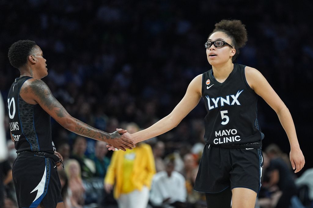 Minnesota Lynx guards Courtney Williams (10) and Olivia Miles (5) high-five during the second half of a WNBA basketball game against the Atlanta Dream Wednesday, May 27, 2026, in Minneapolis. (AP Photo/Abbie Parr)