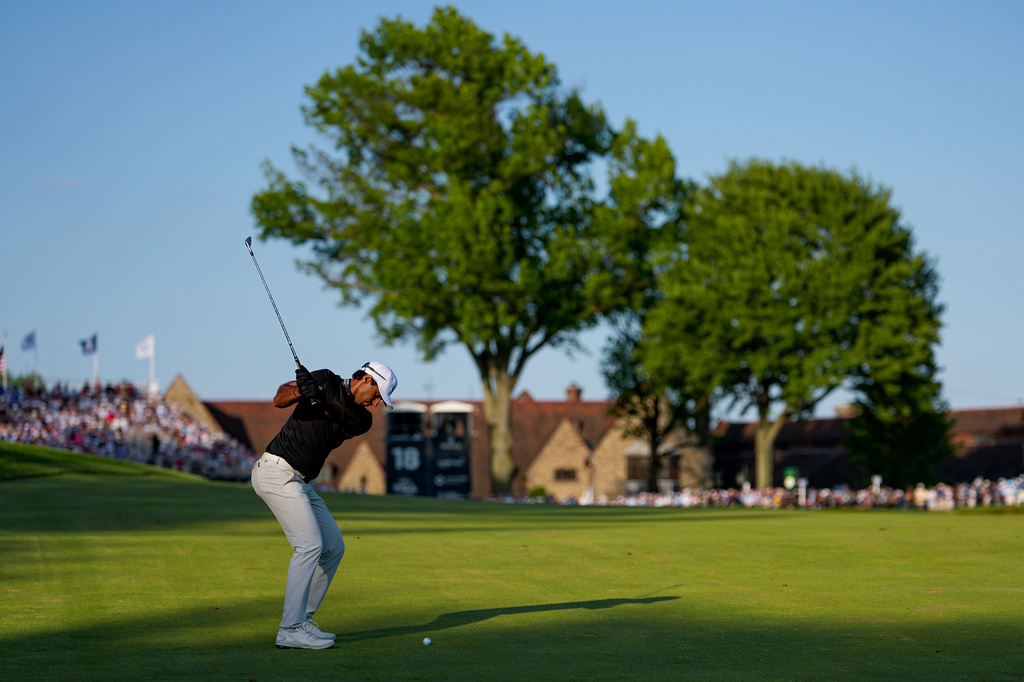 Aaron Rai, of England, hits his approach shot from the 18th fairway during the final round of the PGA Championship golf tournament at Aronimink Golf Club, Sunday, May 17, 2026, in Newtown Square, PA. (AP Photo/Carolyn Kaster)